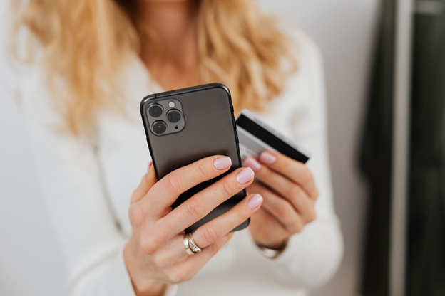 A Gen Z woman shopping online via her smart phone.