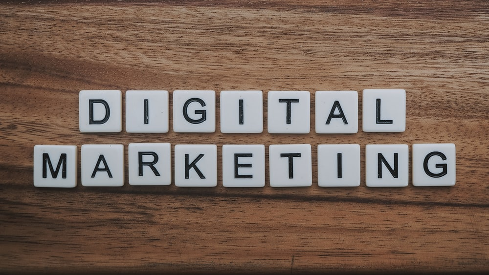 scrabble tiles on wooden table spelling out the term, ‘Digital Marketing’