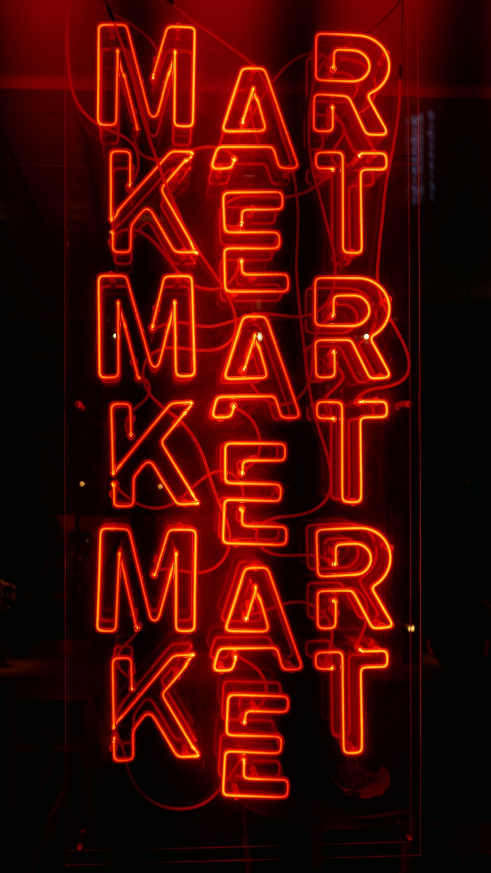 a red neon sign spelling market
